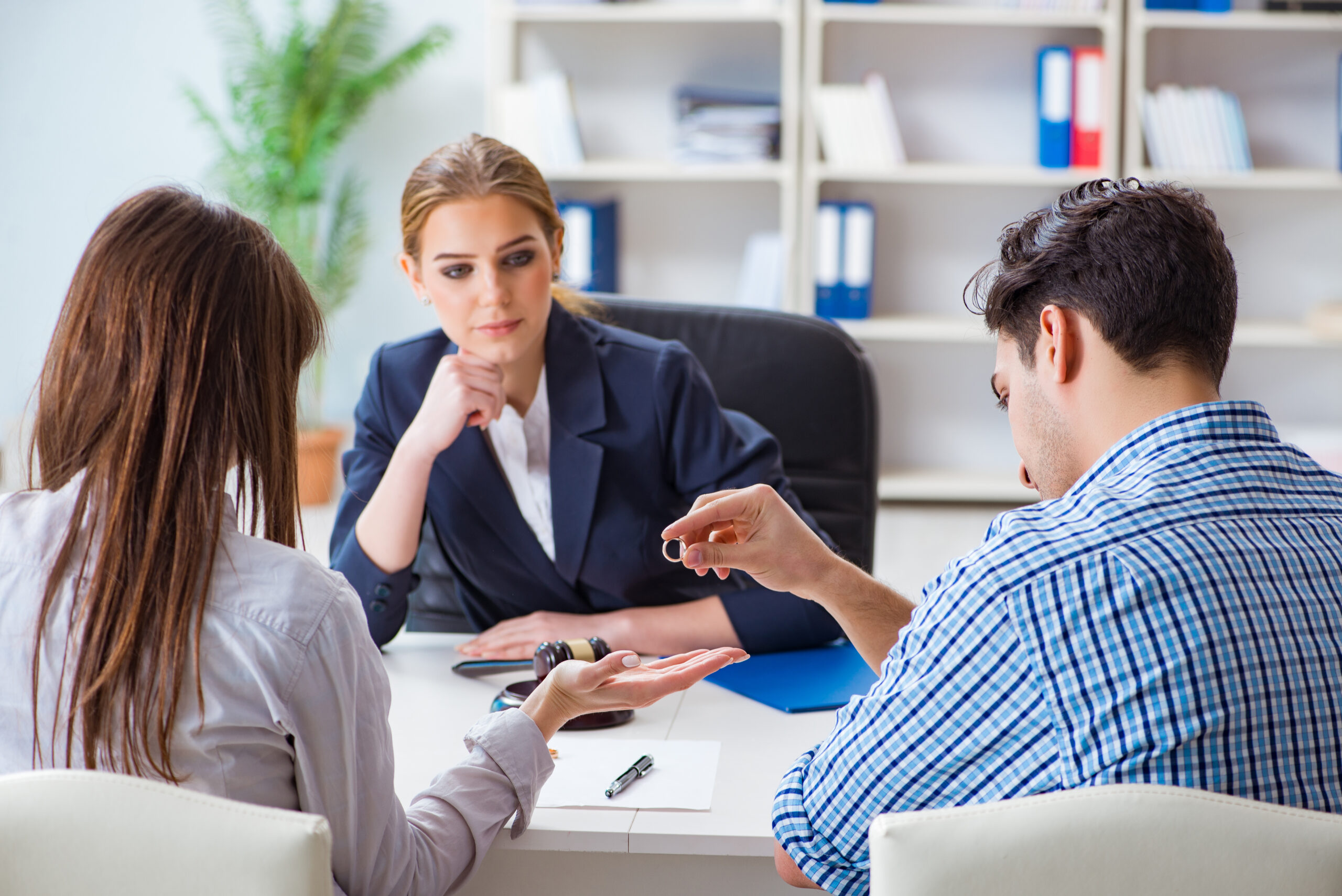 Young family filing divorce papers with lawyer Benefits of Hiring a Divorce Attorney Specializing in Finance