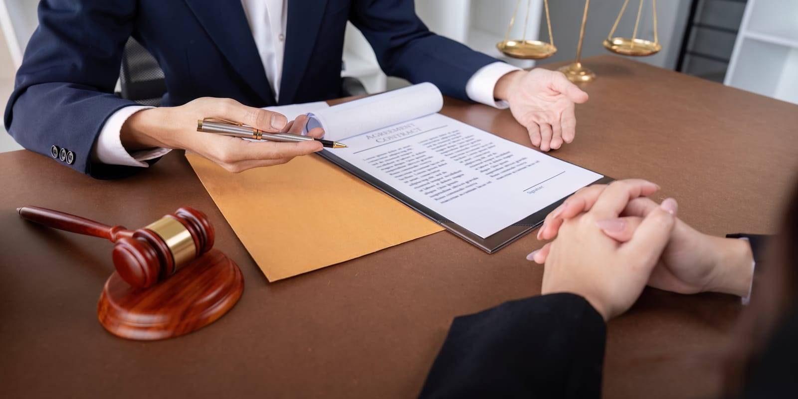 Image of a professional lawyer signing a business contract in an office setting, with legal documents and a gavel on the desk, featuring the 411 Divorce logo and highlighting 'When a Lawyer is Essential: Complex Divorce Situations,' aligning with the page's focus on the importance of legal expertise in complicated divorce cases.